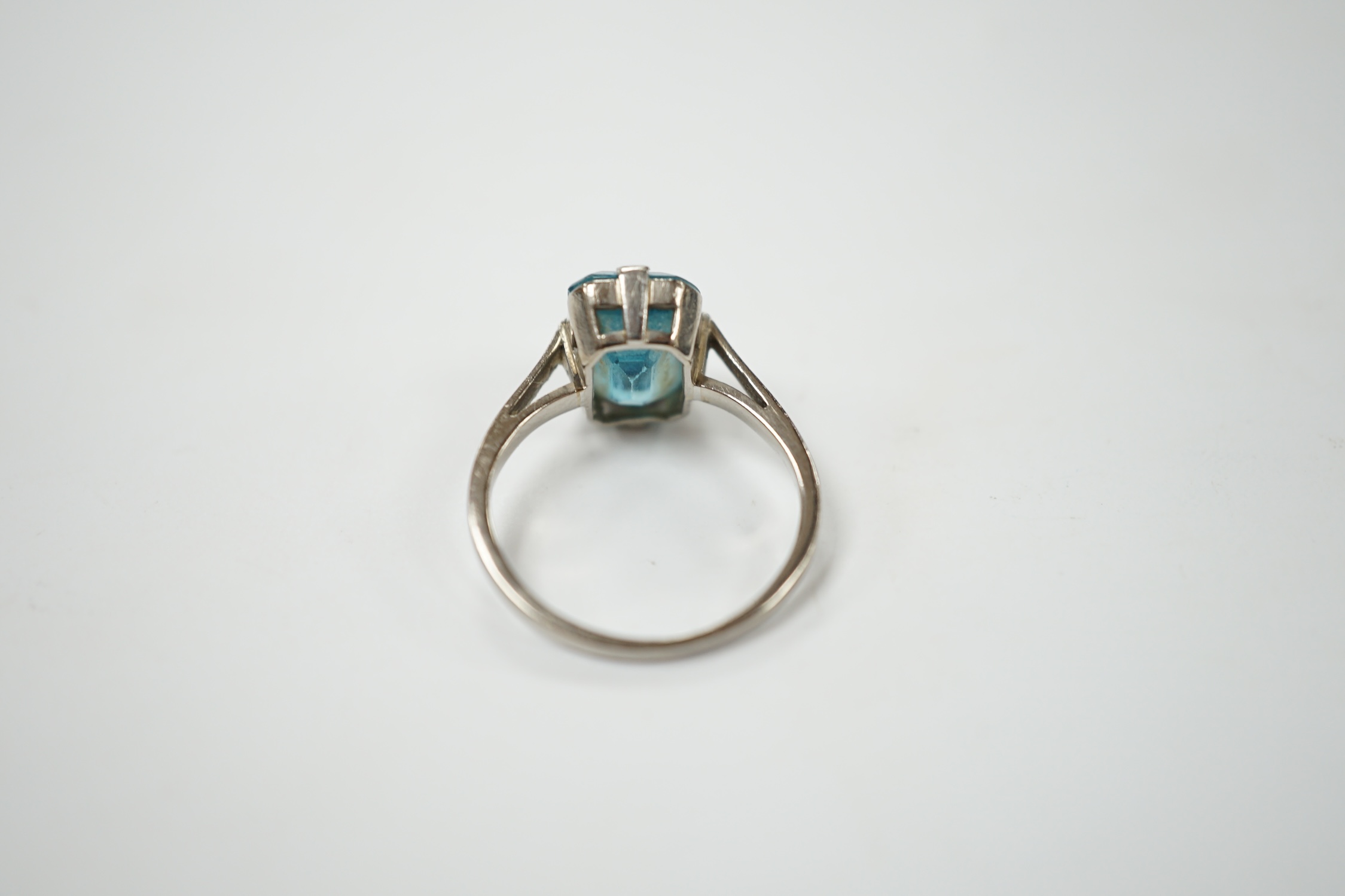 A mid 20th century white metal (stamped platinum) and single stone emerald cut blue zircon set ring, size K, gross weight 3.9 grams. Condition - poor to fair